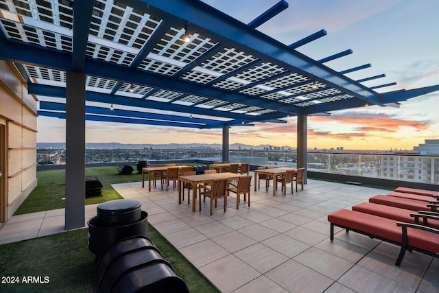 patio terrace at dusk featuring a pergola