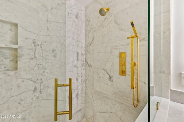 bathroom featuring a marble finish shower