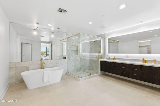 bathroom with a marble finish shower, double vanity, recessed lighting, visible vents, and a freestanding bath