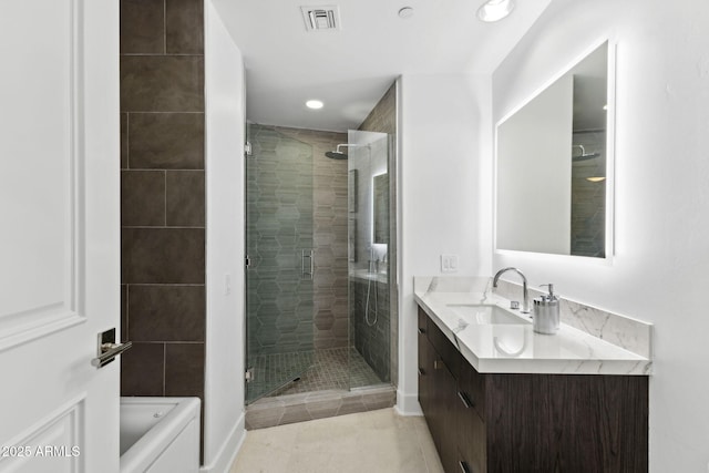 bathroom featuring a stall shower, vanity, visible vents, and tile patterned floors