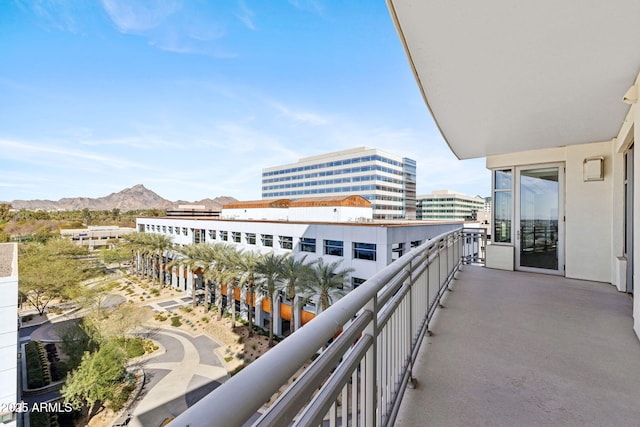 balcony featuring a city view and a mountain view