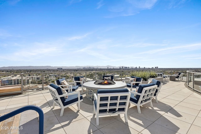 view of patio / terrace featuring a fire pit and a mountain view