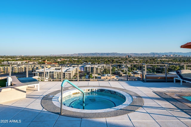 view of swimming pool featuring a mountain view and a hot tub