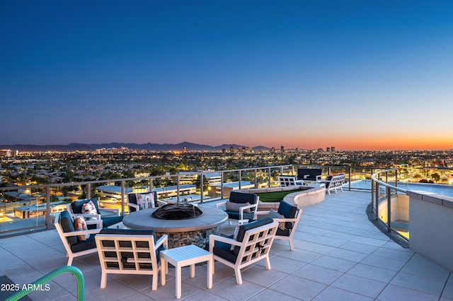 view of patio / terrace with a mountain view and a fire pit