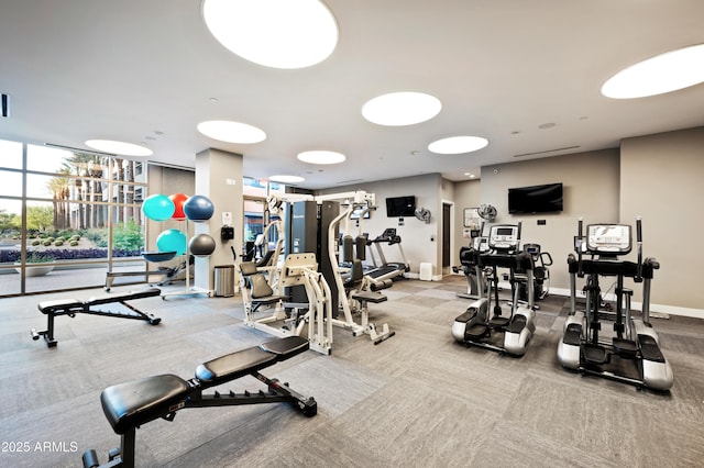 gym featuring expansive windows and baseboards