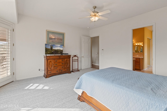 carpeted bedroom featuring access to outside, connected bathroom, and ceiling fan