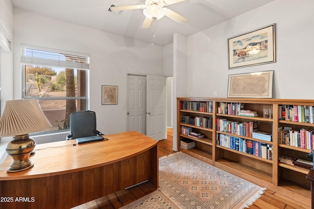 office with ceiling fan and light wood-type flooring