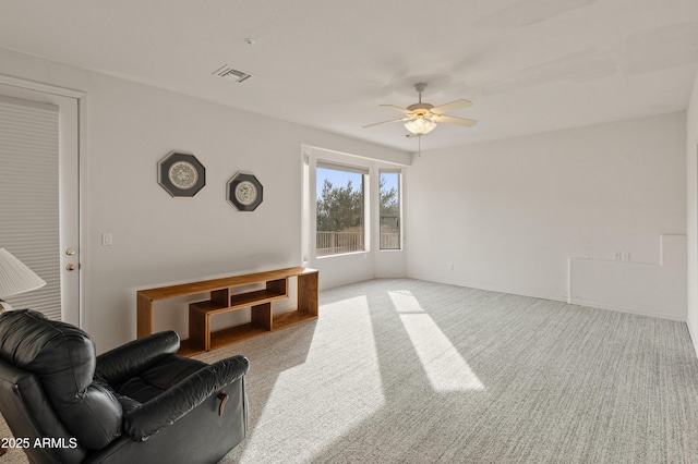 living room with light carpet and ceiling fan