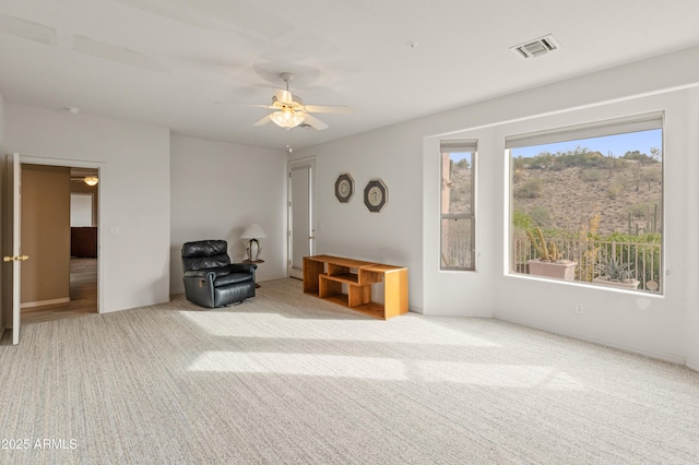 unfurnished room featuring ceiling fan and light carpet