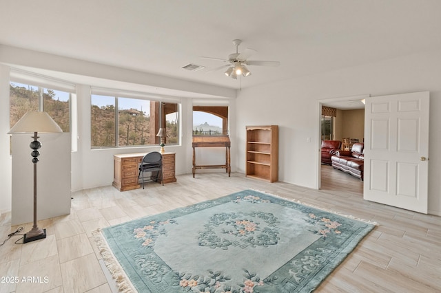 living area with ceiling fan