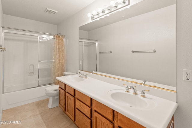 full bathroom featuring tile patterned flooring, vanity, toilet, and enclosed tub / shower combo