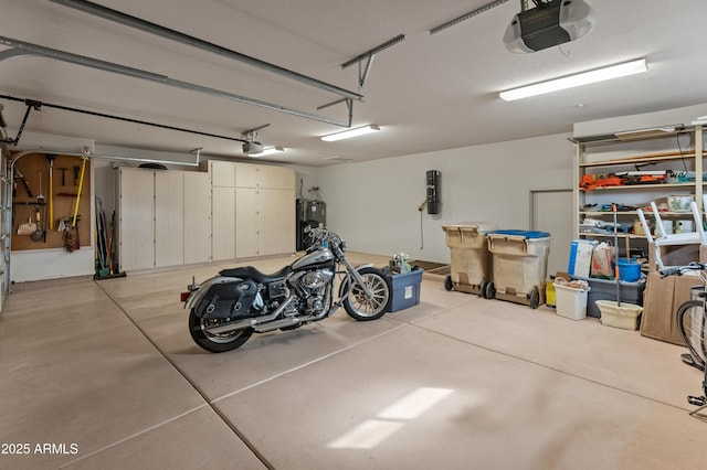 garage with electric water heater and a garage door opener