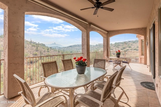 view of patio / terrace with a mountain view and ceiling fan