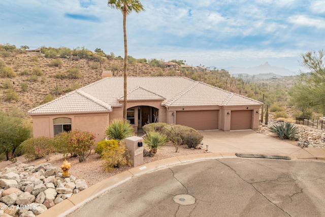 view of front of property featuring a mountain view and a garage