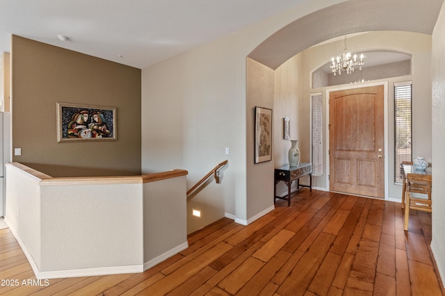 foyer with a chandelier and hardwood / wood-style flooring