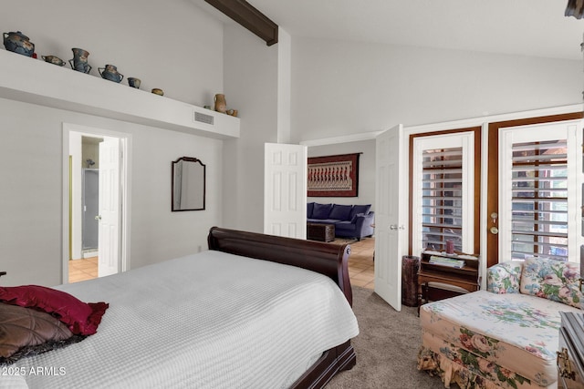 carpeted bedroom with high vaulted ceiling and beamed ceiling