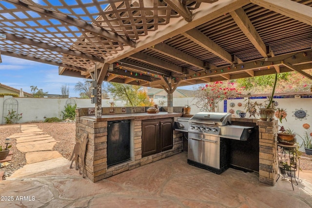 view of patio with a pergola and exterior kitchen