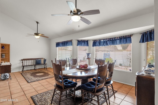 dining area featuring ceiling fan, tile patterned flooring, vaulted ceiling, and a healthy amount of sunlight