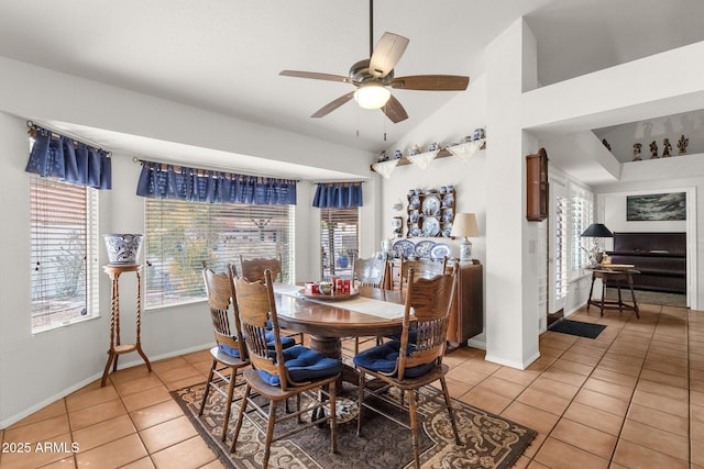 dining room with tile patterned floors, vaulted ceiling, ceiling fan, and a healthy amount of sunlight