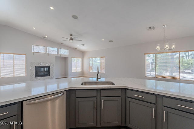 kitchen with a sink, gray cabinets, visible vents, stainless steel dishwasher, and ceiling fan with notable chandelier