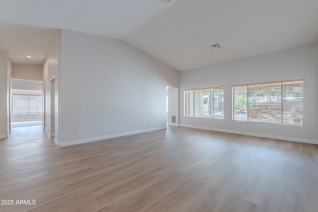 unfurnished living room with visible vents, light wood finished floors, and baseboards