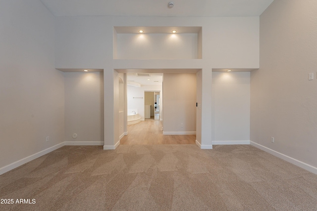 unfurnished room featuring baseboards and carpet floors