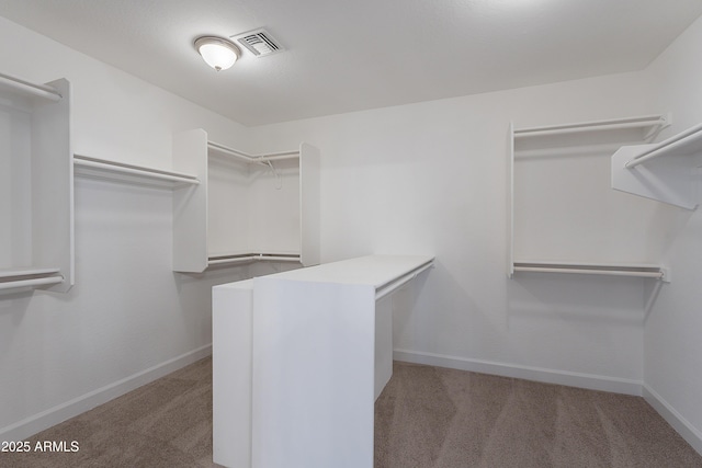spacious closet with visible vents and carpet