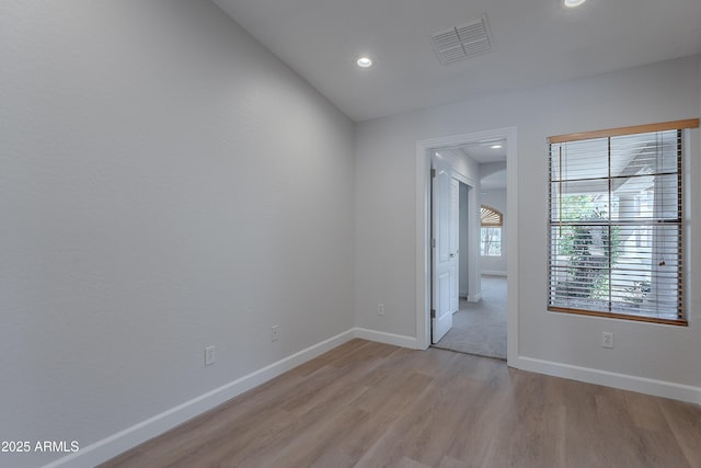 spare room featuring visible vents, recessed lighting, light wood finished floors, and baseboards