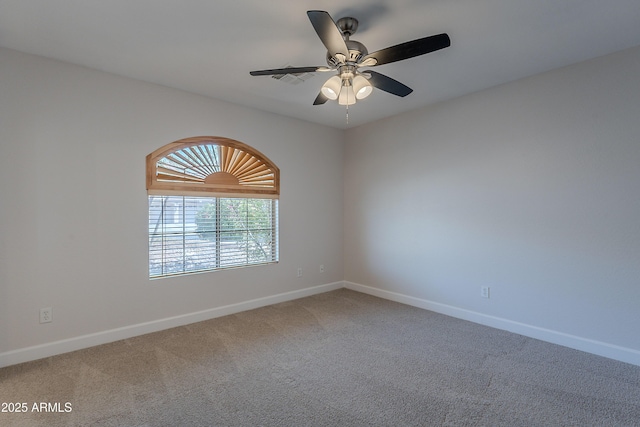 carpeted spare room featuring visible vents, ceiling fan, and baseboards