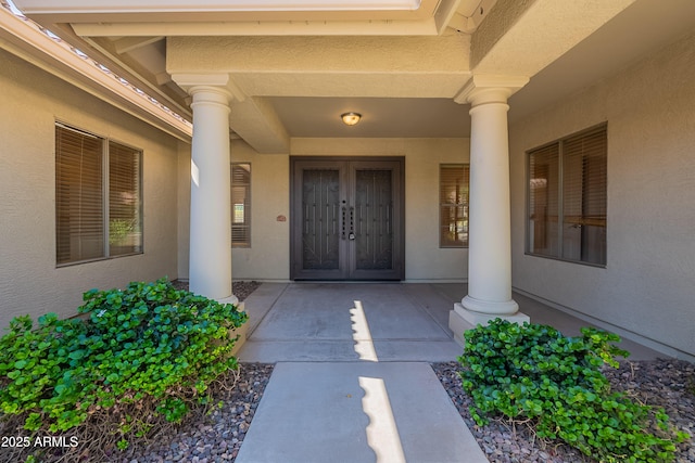 doorway to property with french doors and stucco siding