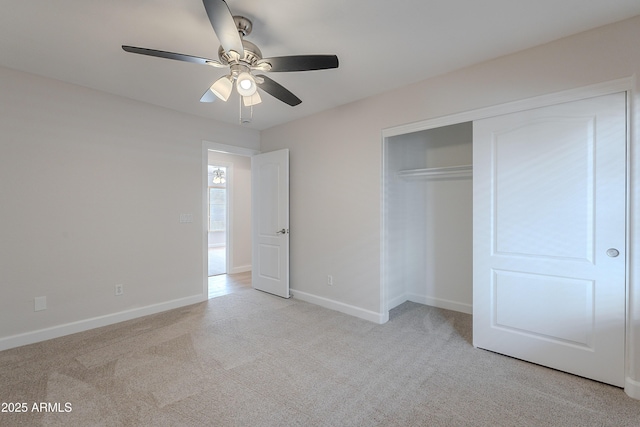 unfurnished bedroom with a closet, baseboards, and light carpet