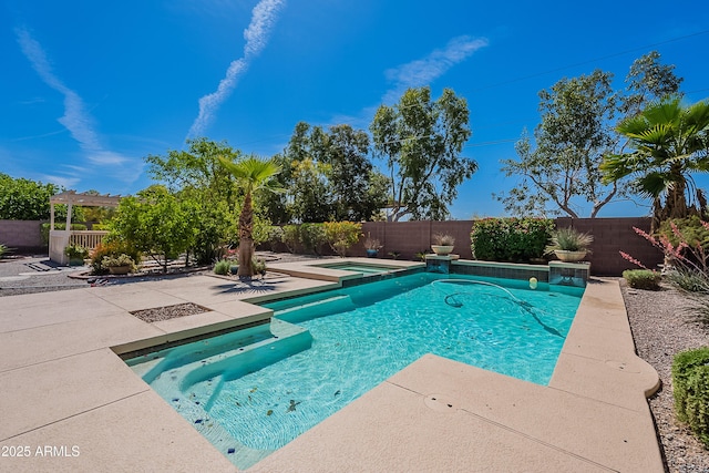 view of pool with a fenced in pool, a fenced backyard, an in ground hot tub, and a patio area