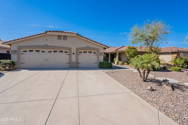 13305 W Colter St, Litchfield Park, AZ 85340 - view of front of home with stucco siding, driveway, an attached garage, and a tiled roof