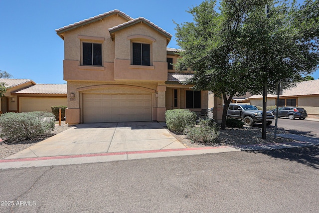125 N 22nd Pl Unit 14, Mesa, AZ 85213 - view of front of house featuring stucco siding, an attached garage, a tile roof, and driveway