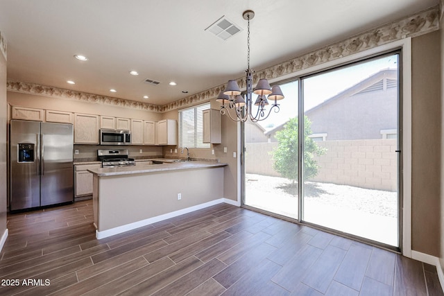 125 N 22nd Pl Unit 14, Mesa, AZ 85213 - kitchen featuring stainless steel appliances, a sink, a chandelier, baseboards, and dark wood-type flooring