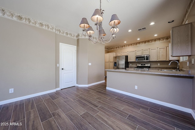 125 N 22nd Pl Unit 14, Mesa, AZ 85213 - kitchen featuring appliances with stainless steel finishes, a sink, a chandelier, baseboards, and wood tiled floors