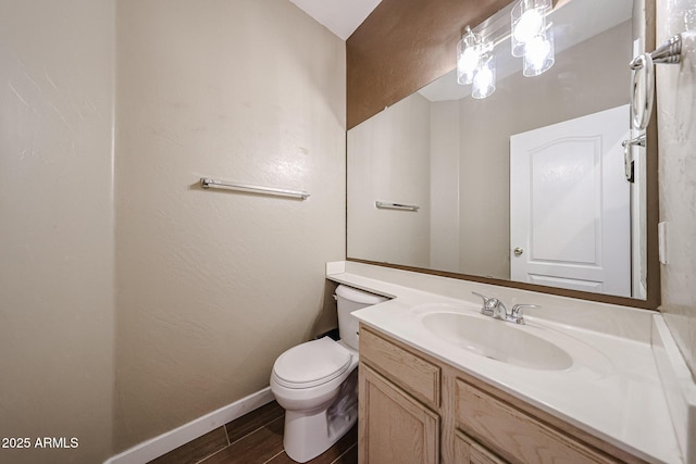 125 N 22nd Pl Unit 14, Mesa, AZ 85213 - bathroom with vanity, wood finished floors, toilet, and baseboards