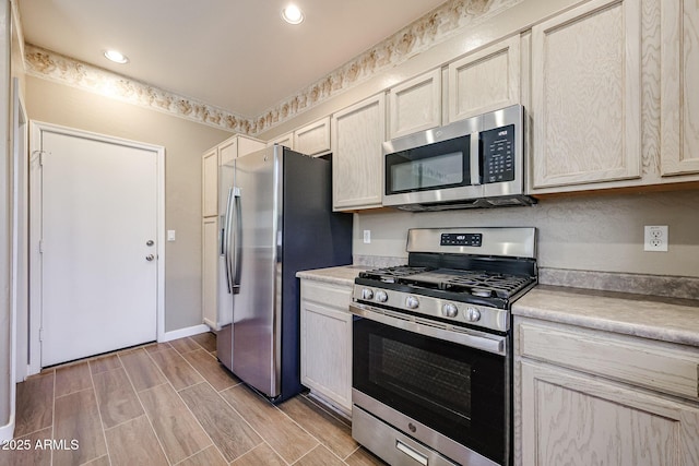 125 N 22nd Pl Unit 14, Mesa, AZ 85213 - kitchen with stainless steel appliances, light countertops, baseboards, wood tiled floors, and recessed lighting