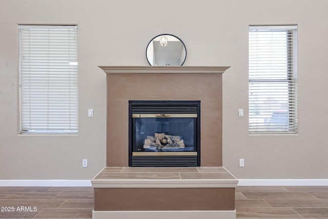 125 N 22nd Pl Unit 14, Mesa, AZ 85213 - detailed view of wood finish floors, baseboards, and a glass covered fireplace