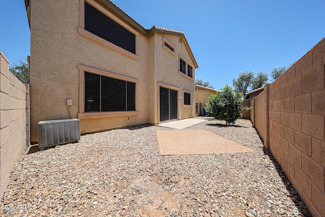 125 N 22nd Pl Unit 14, Mesa, AZ 85213 - rear view of property with central AC, stucco siding, a fenced backyard, and a patio