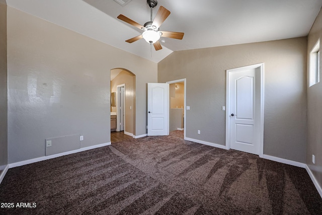 125 N 22nd Pl Unit 14, Mesa, AZ 85213 - unfurnished bedroom with arched walkways, carpet floors, baseboards, connected bathroom, and lofted ceiling