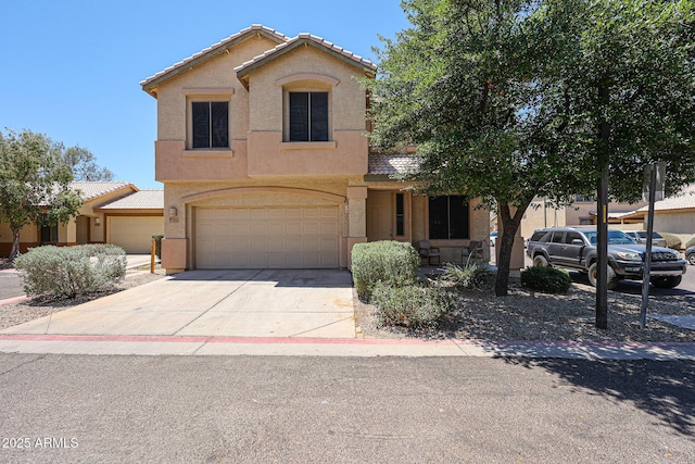 125 N 22nd Pl Unit 14, Mesa, AZ 85213 - view of front of home featuring an attached garage, stucco siding, concrete driveway, and a tiled roof