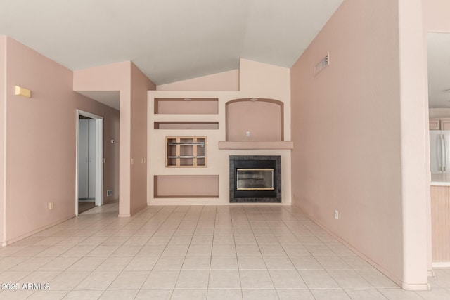 24907 S Lakestar Dr, Sun Lakes, AZ 85248 - unfurnished living room with lofted ceiling, a tiled fireplace, light tile patterned floors, and baseboards