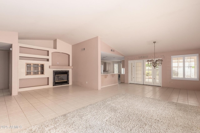 24907 S Lakestar Dr, Sun Lakes, AZ 85248 - unfurnished living room featuring light tile patterned floors, lofted ceiling, and a tile fireplace