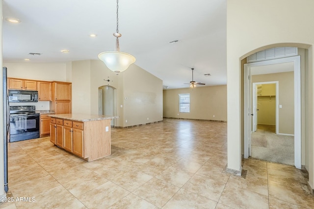 kitchen with a center island, black appliances, light stone countertops, ceiling fan, and pendant lighting