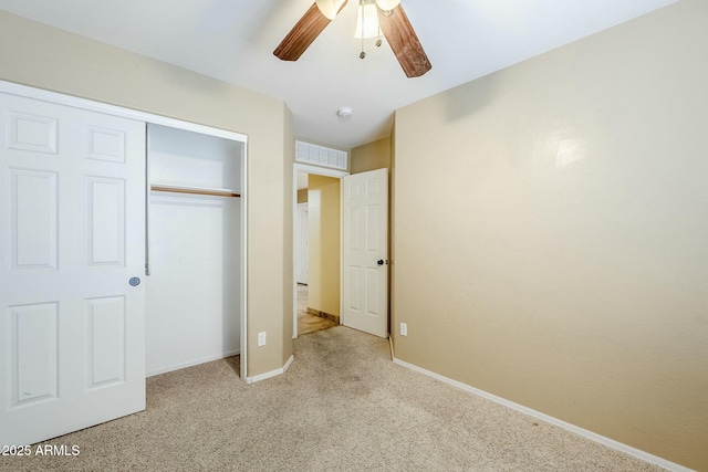 unfurnished bedroom with ceiling fan, light colored carpet, and a closet