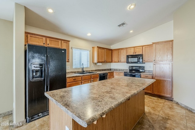 kitchen featuring vaulted ceiling, sink, light tile patterned floors, a kitchen island, and black appliances