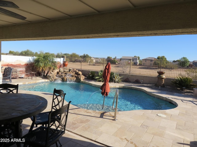 view of swimming pool with a patio and pool water feature