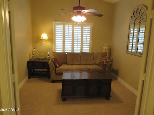 living room with ceiling fan, light carpet, and a wealth of natural light