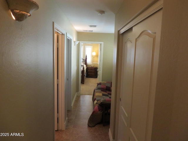 hallway featuring light tile patterned flooring